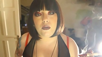 Obese Female Dominant Tina Smua Puffs On A Unfiltered Cigarette Using A Holder